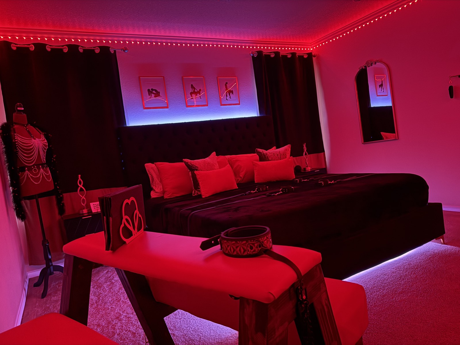 The Red Chamber suite in signature red mood lighting with curated details